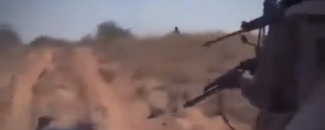 Sudan Genocide in El Fasher banner for article, shows RSF fighters firing into detained civilians